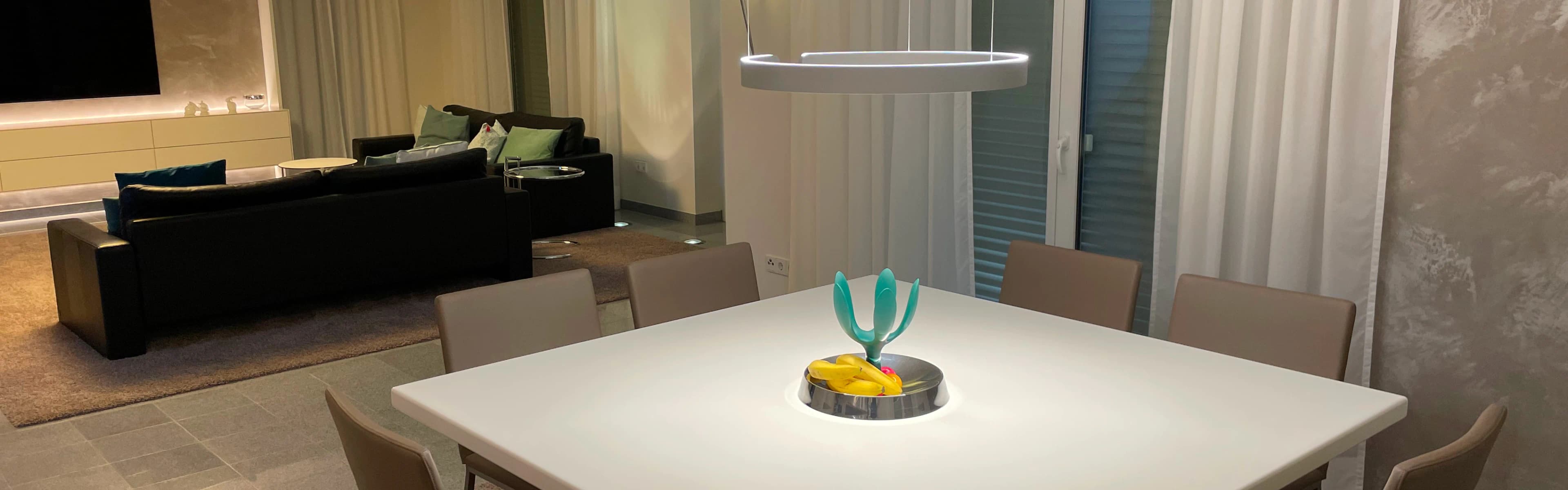 Wohnzimmer mit brauner Couch und edlem Beistelltisch und Lampe